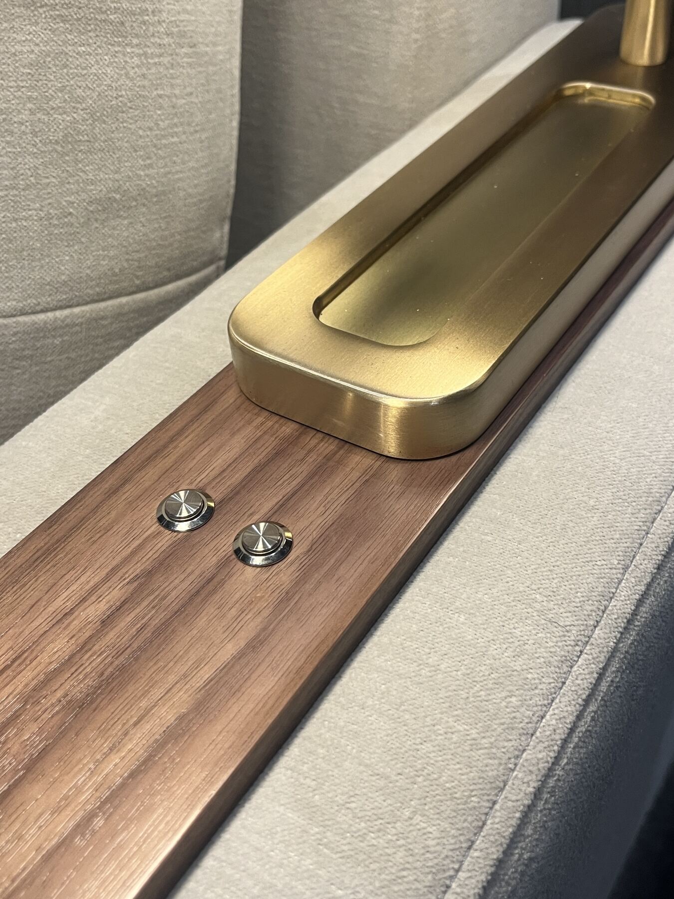 Walnut arm cap with brushed brass tray and two integrated control buttons