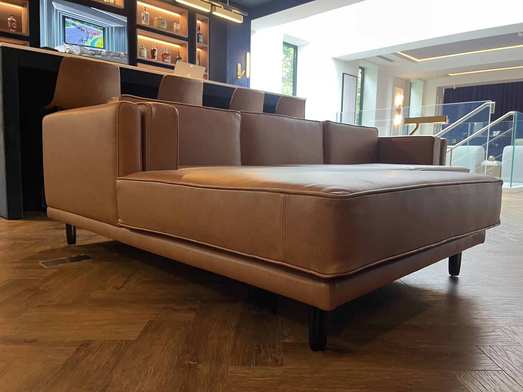 Larsen in tan leather, detail of the layered arm and piped edges