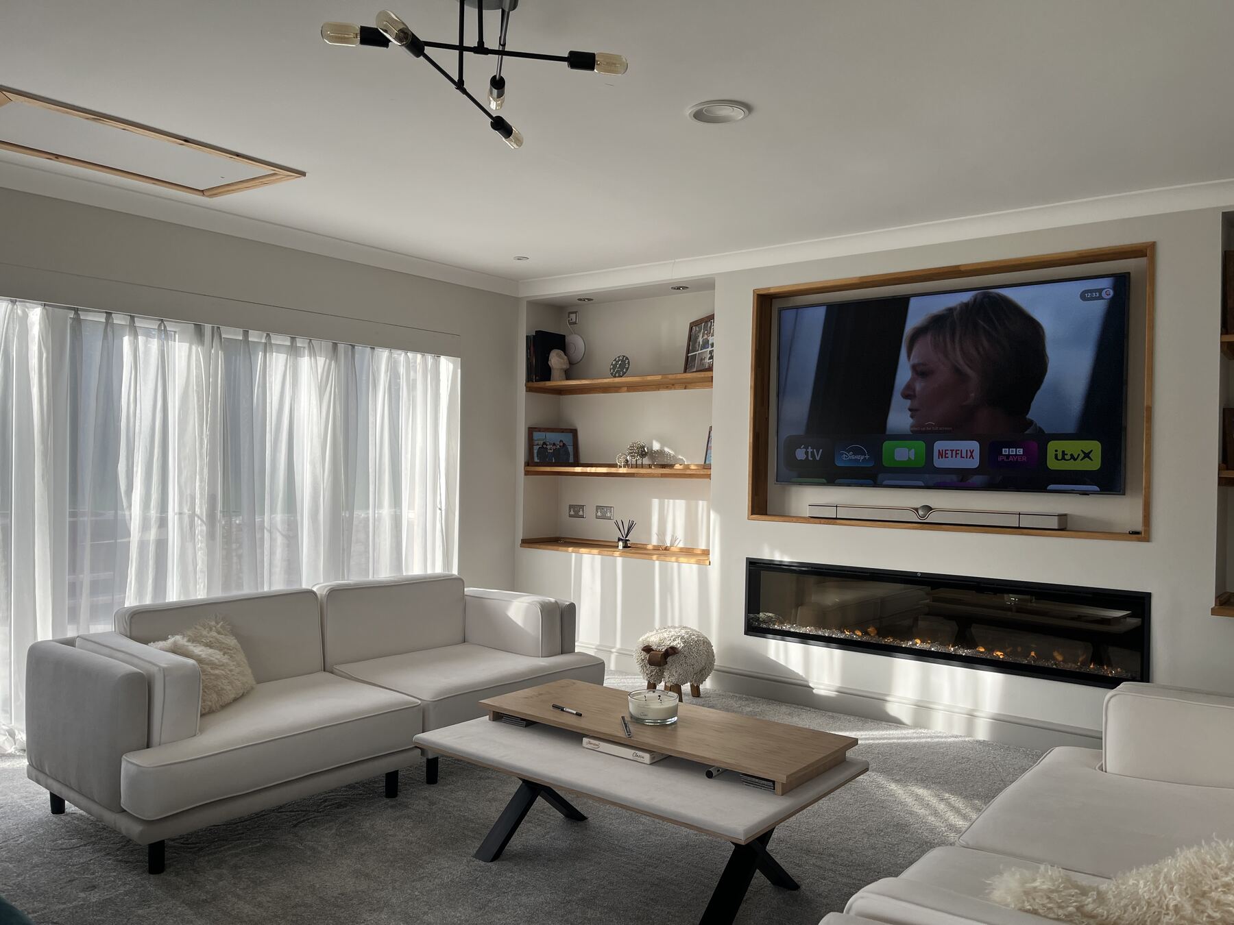 A pair of Larsen sofas in ivory fabric in a family living room